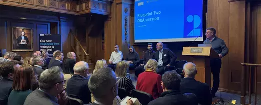 Image of crowd and speakers at 10 January Q&A session